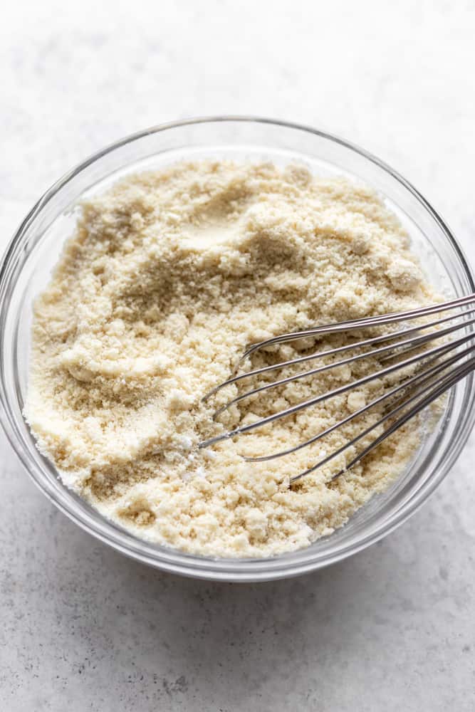 a whisk in a bowl of almond flour