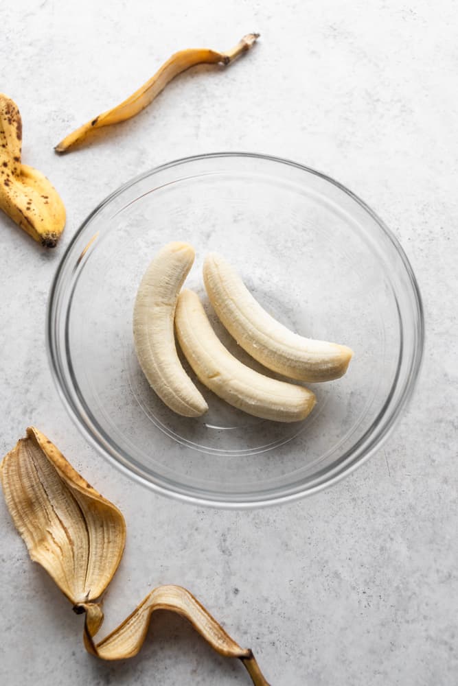 three bananas in a clear bowl