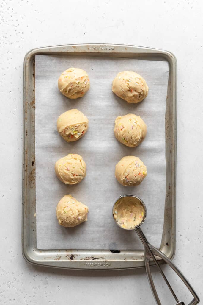 Cookie dough scooped onto a baking pan.