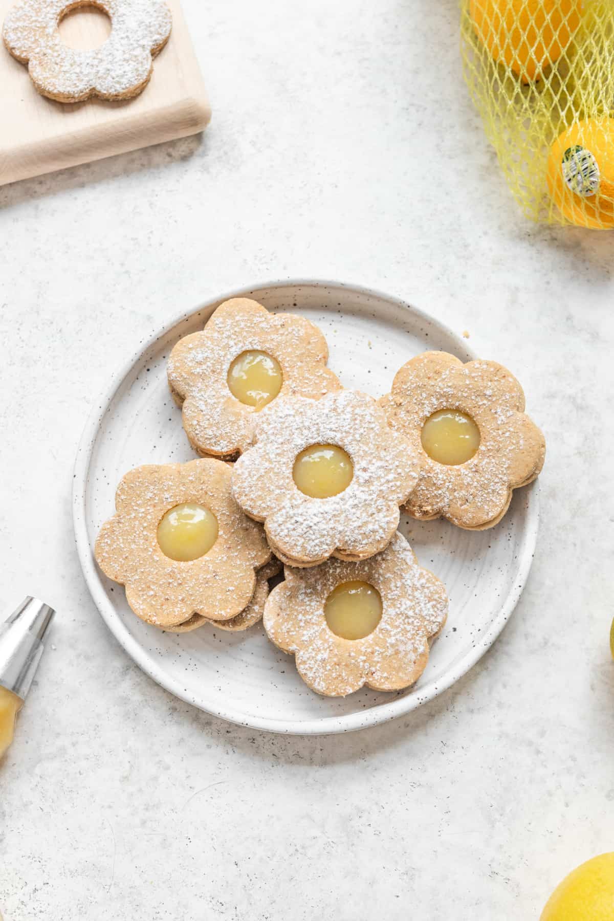 Flower shaped shortbread cookies on a white plate.