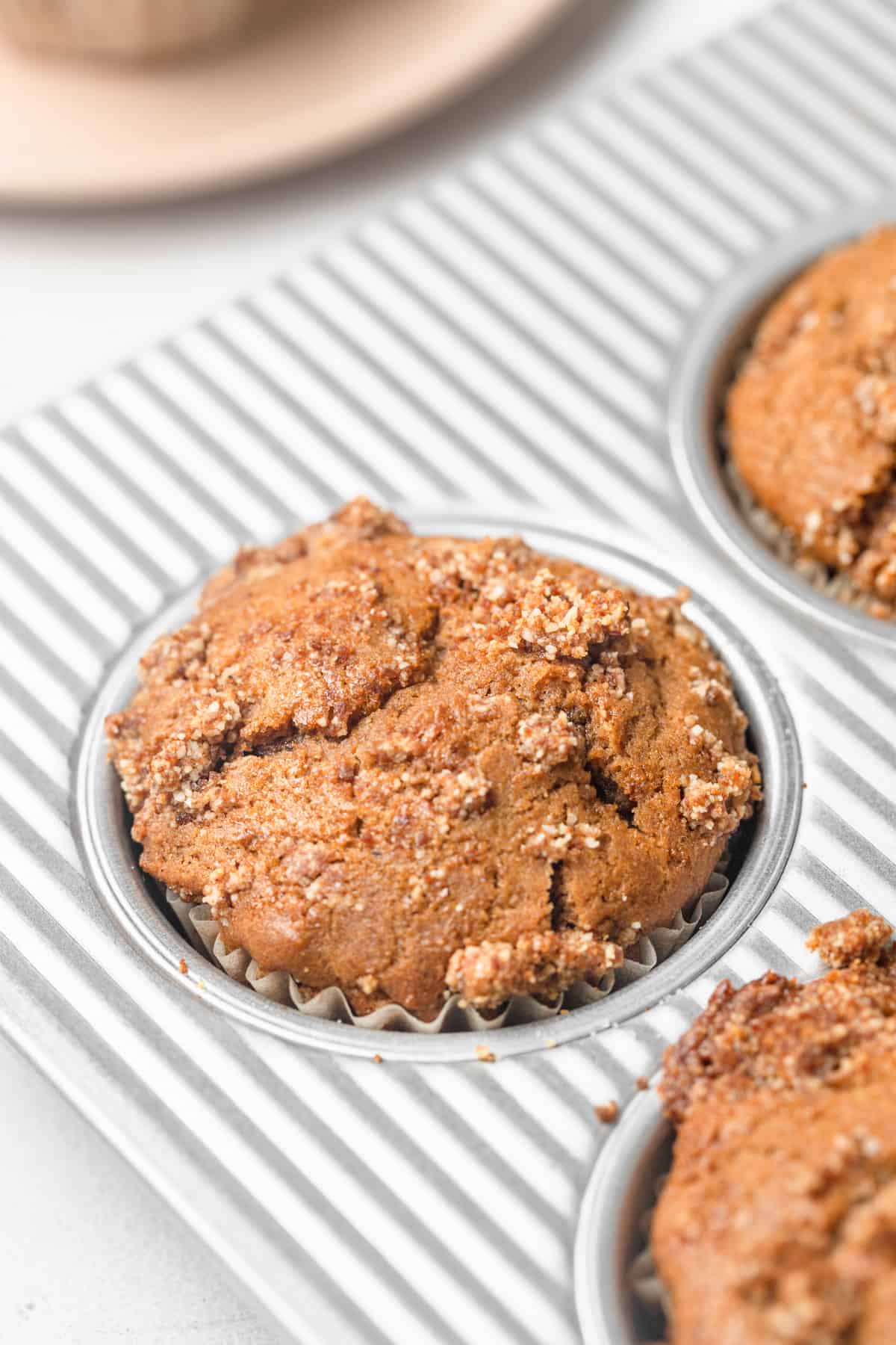 A close up of a muffin in a muffin pan.