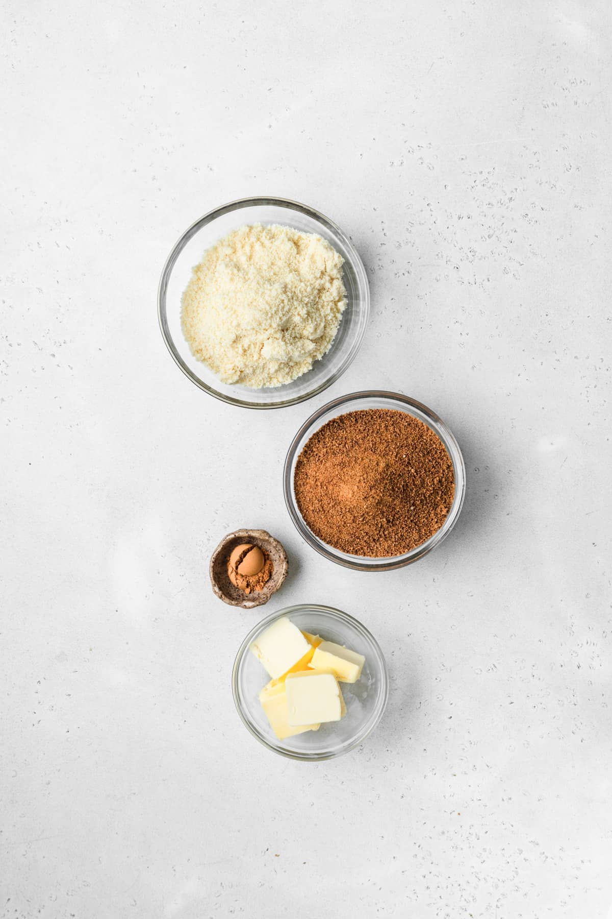 Ingredients to make cinnamon streusel topping on a white surface.