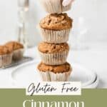 A stack of gluten free cinnamon streusel muffins with a hand grabbing one.