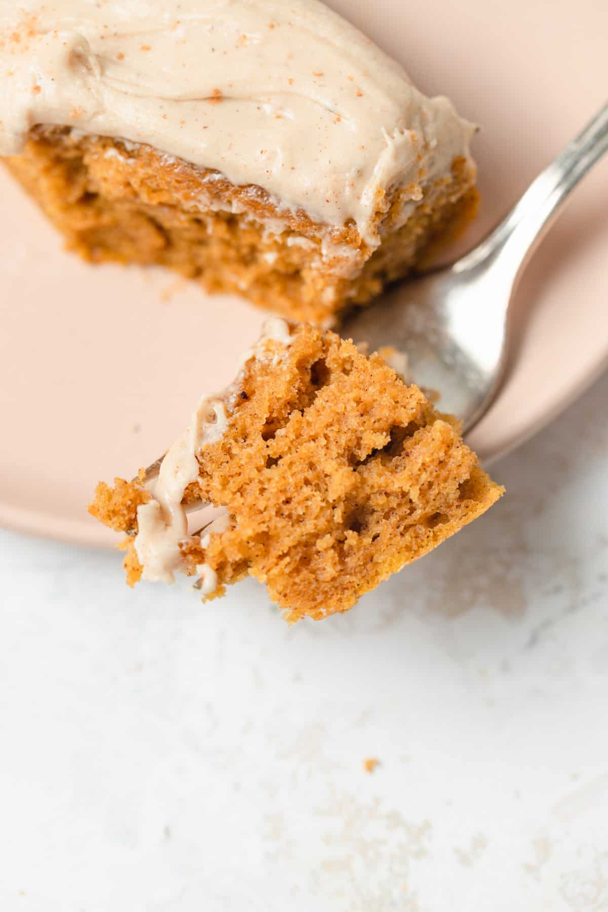 A fork with pumpkin cake on it.
