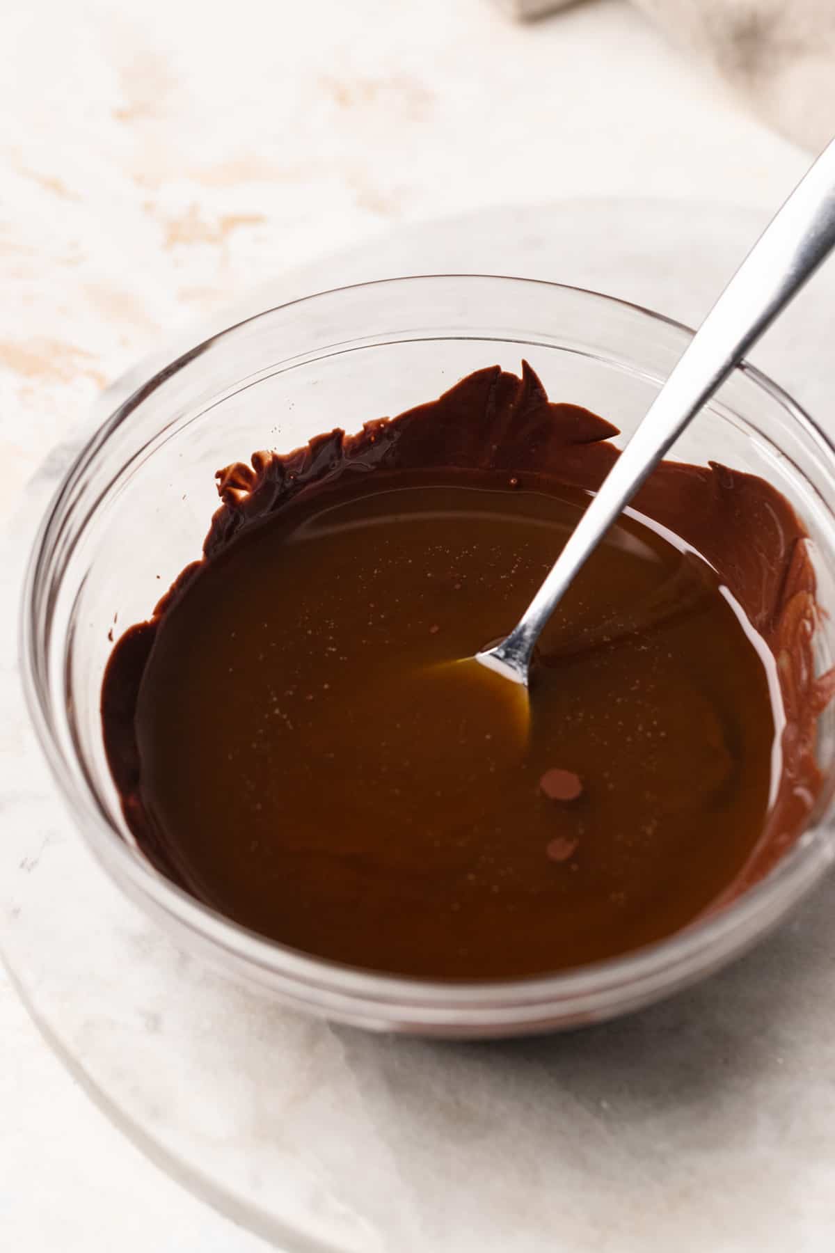 Melted chocolate and olive oil in a bowl.
