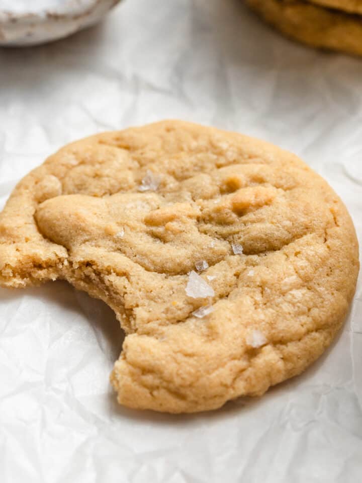A cookie with a bite taken out of it with sea salt on top.