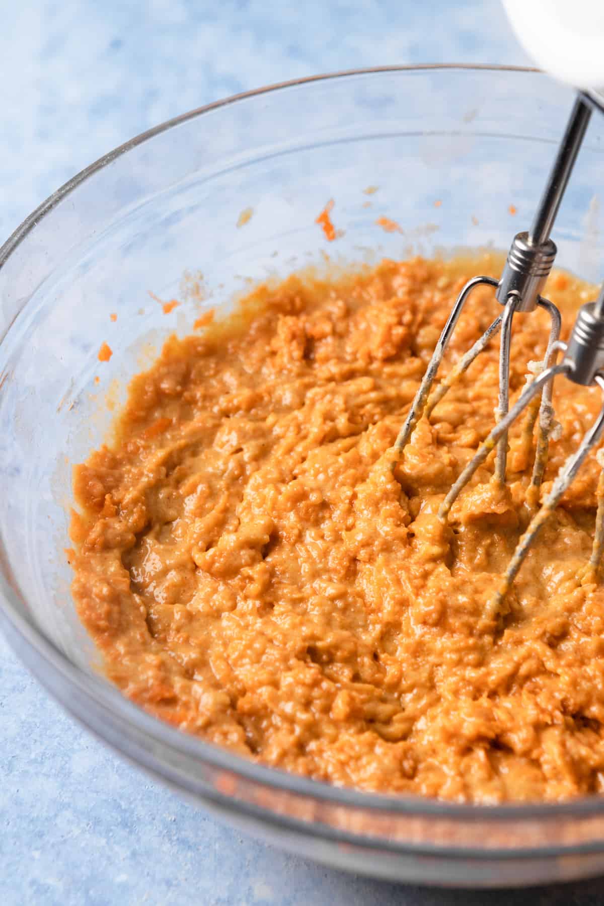 Mixing carrots into cake batter.