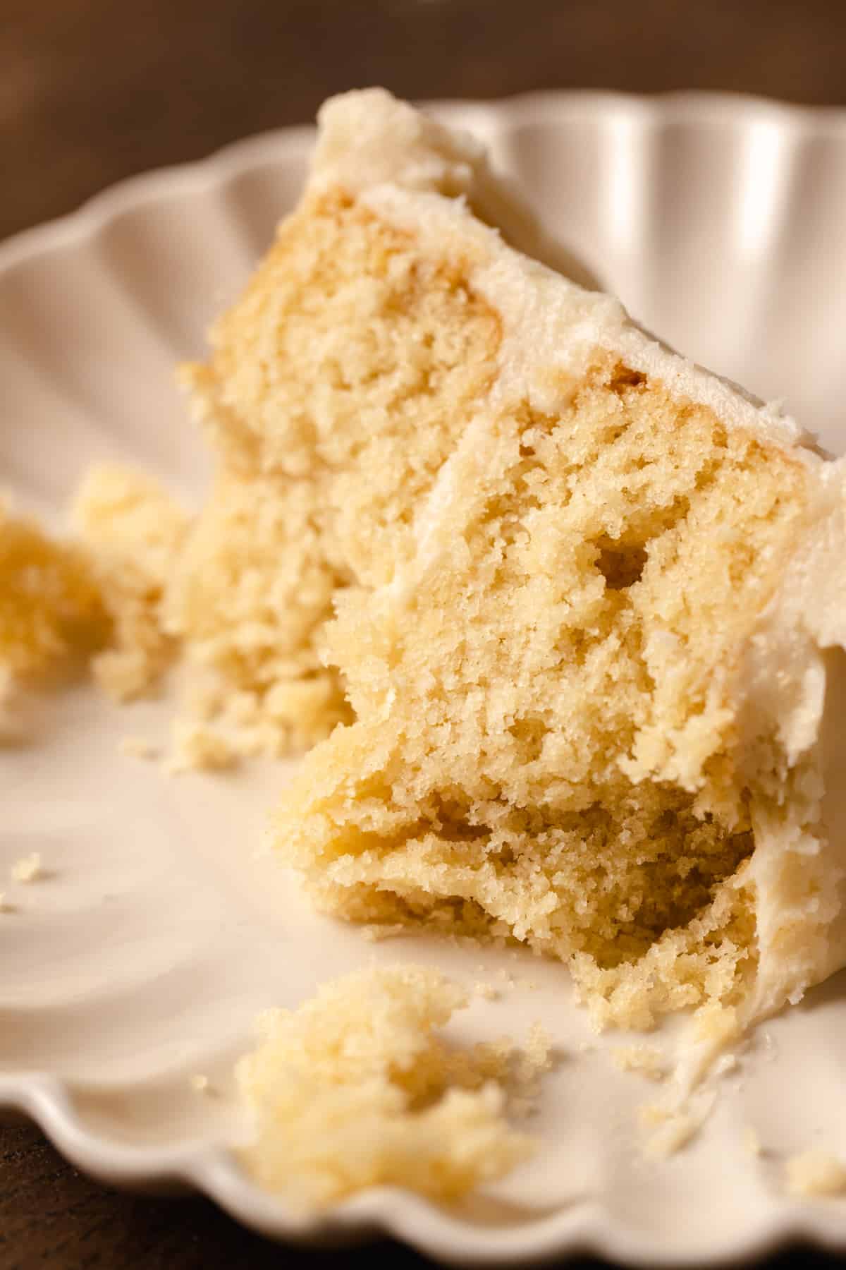 A slice of vanilla cake with bites taken out of it.
