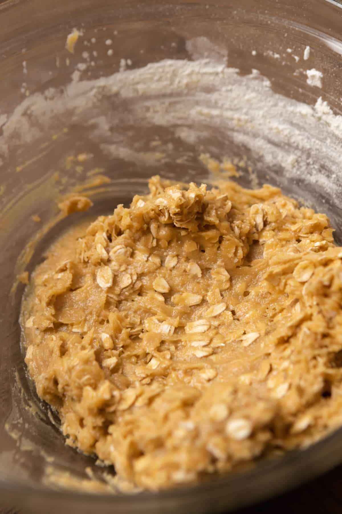 Oatmeal cookie dough in a mixing bowl.