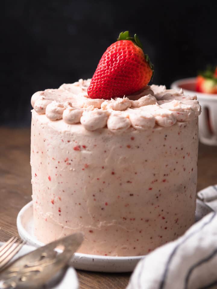 A strawberry vanilla cake on a white plate.