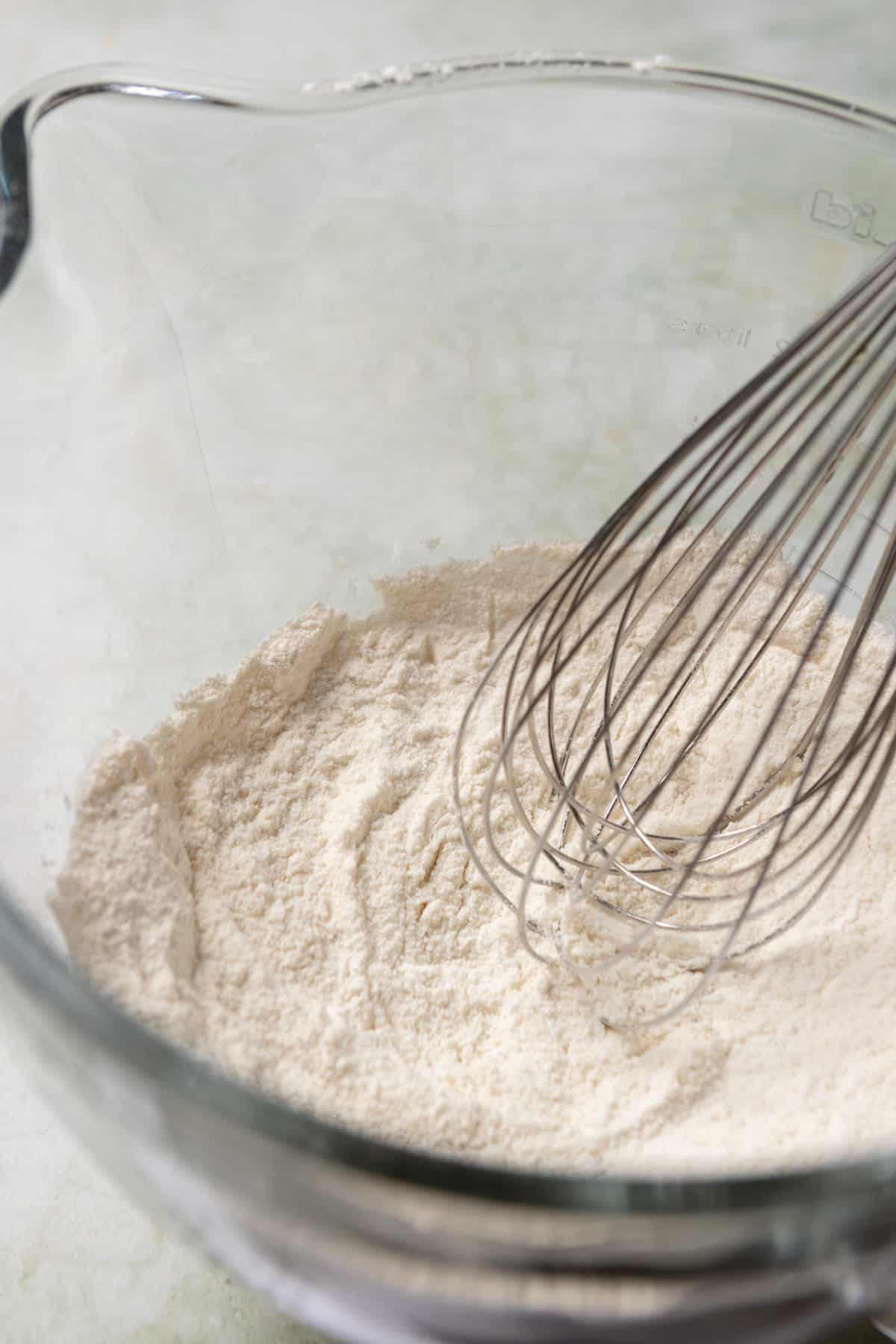 Dry ingredient for cake being whisked in a bowl.