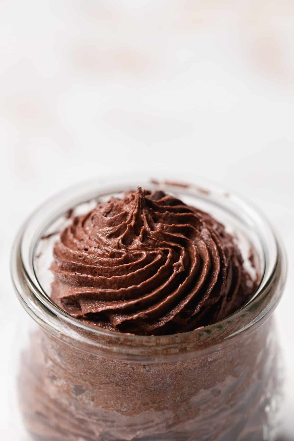 Chocolate frosting in a glass jar.