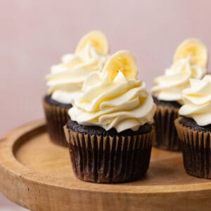 Chocolate banana cupcakes garnished with banana slice.