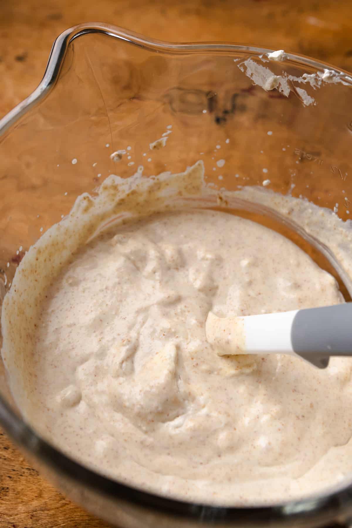 Graham cracker ice cream mixture in a bowl with a rubber spatula.