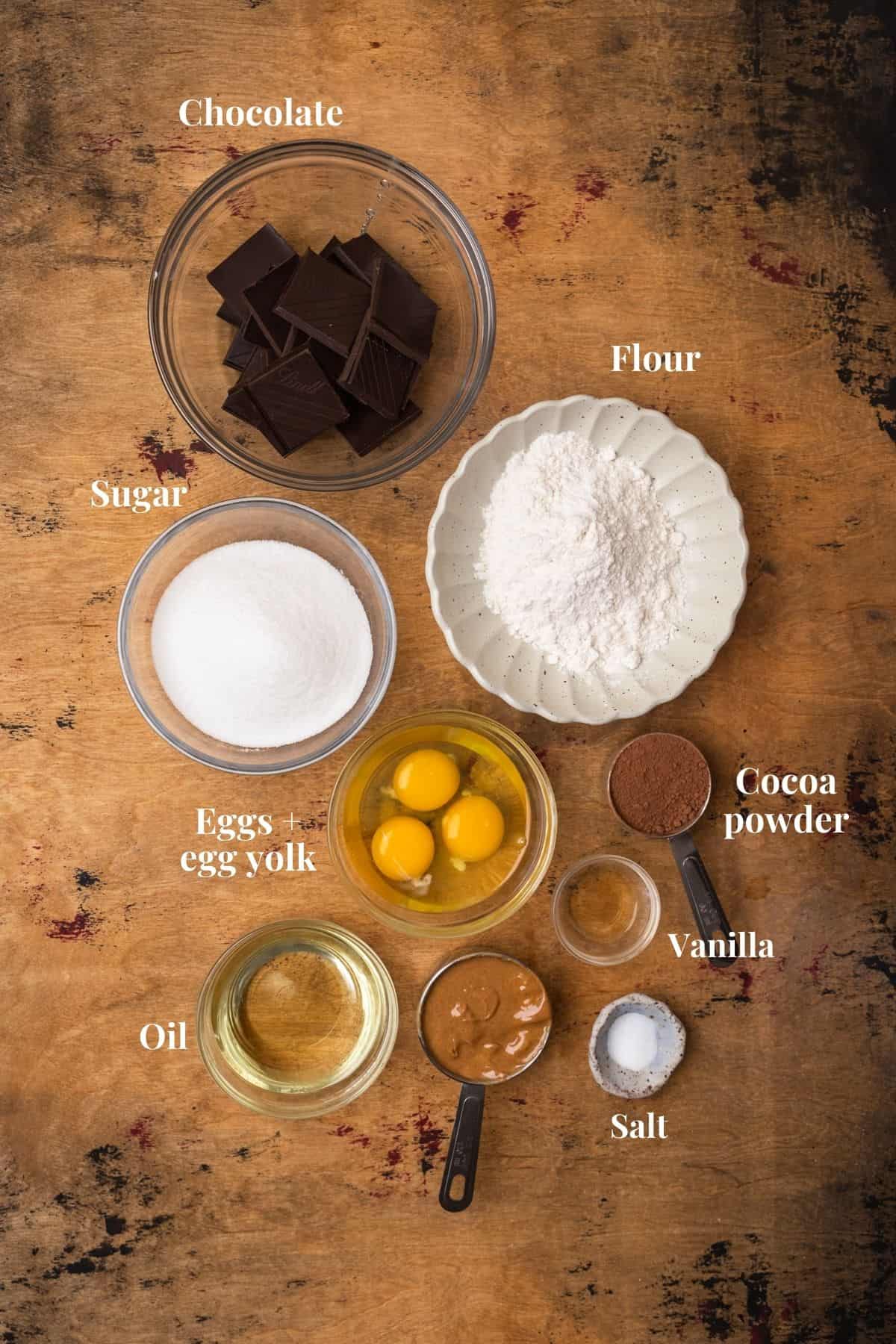 Ingredients to make brownie cookies on a wood surface.