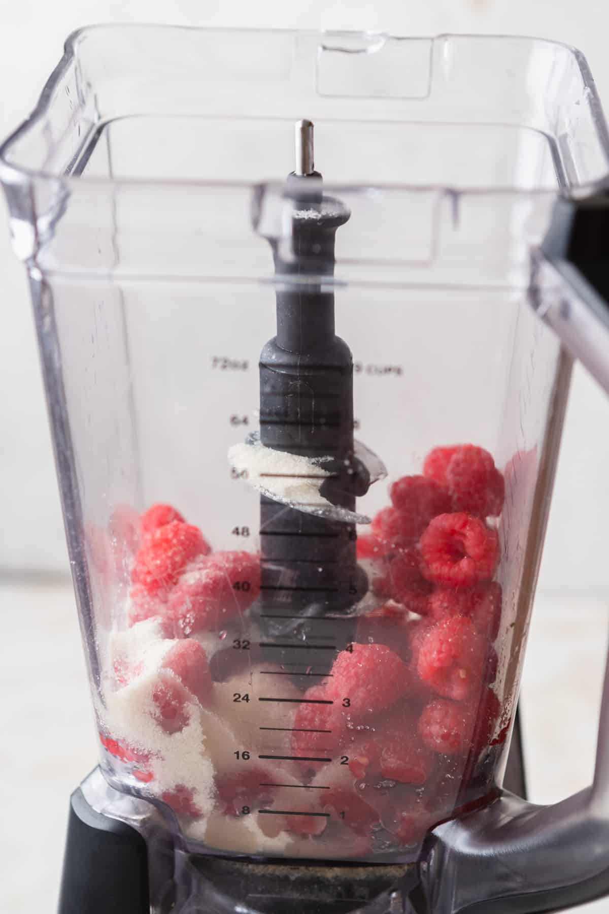 Raspberries, sugar, and lemon juice in a blender.