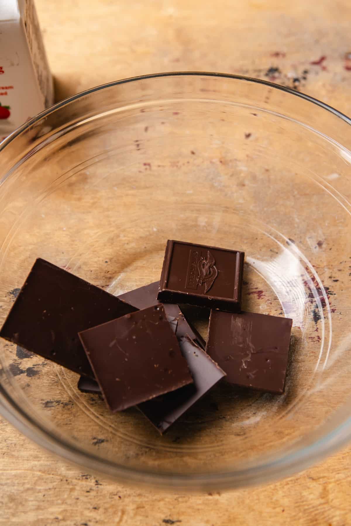 Chocolate squares in a glass mixing bowl.