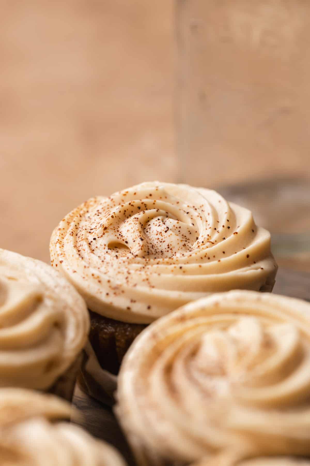 A close up of a cupcake dusted with espresso powder.