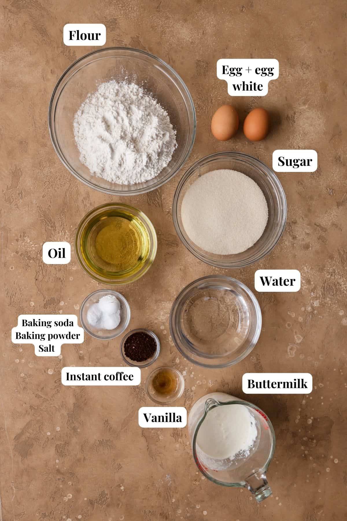 Ingredients to make cupcakes with coffee on a brown surface.