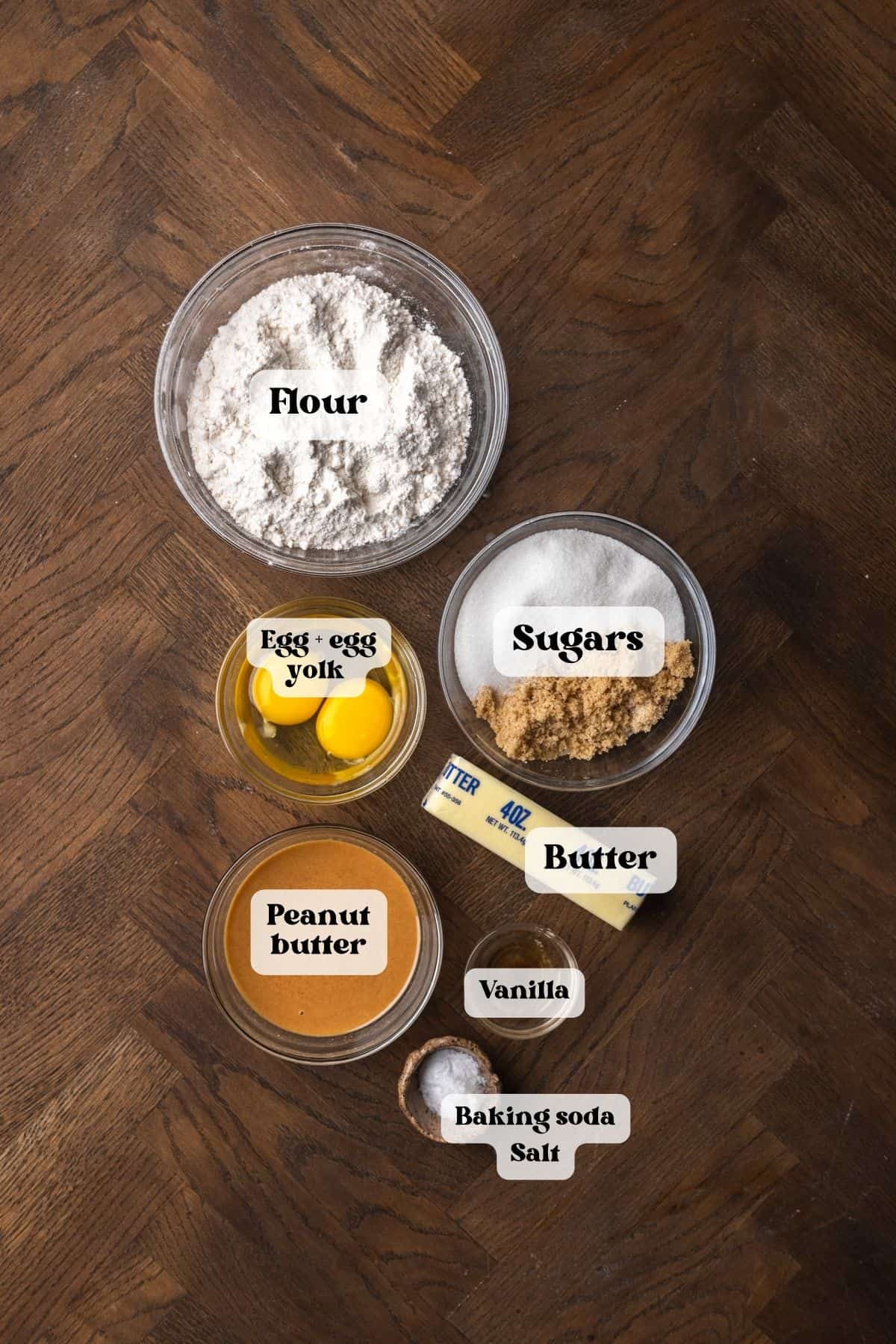 Ingredients to make brown butter peanut butter cookies on a wood surface.