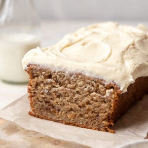 Banana bread on a parchment lined serving board.