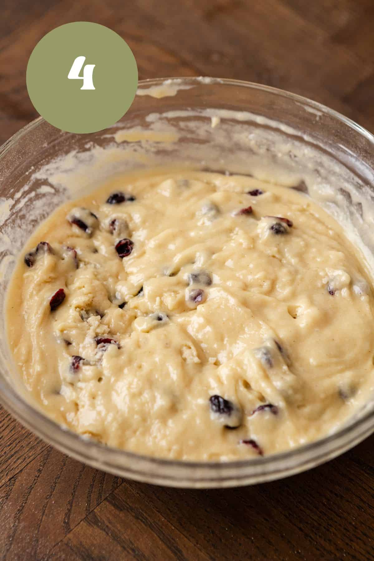 Dried cranberry muffin batter in a bowl.
