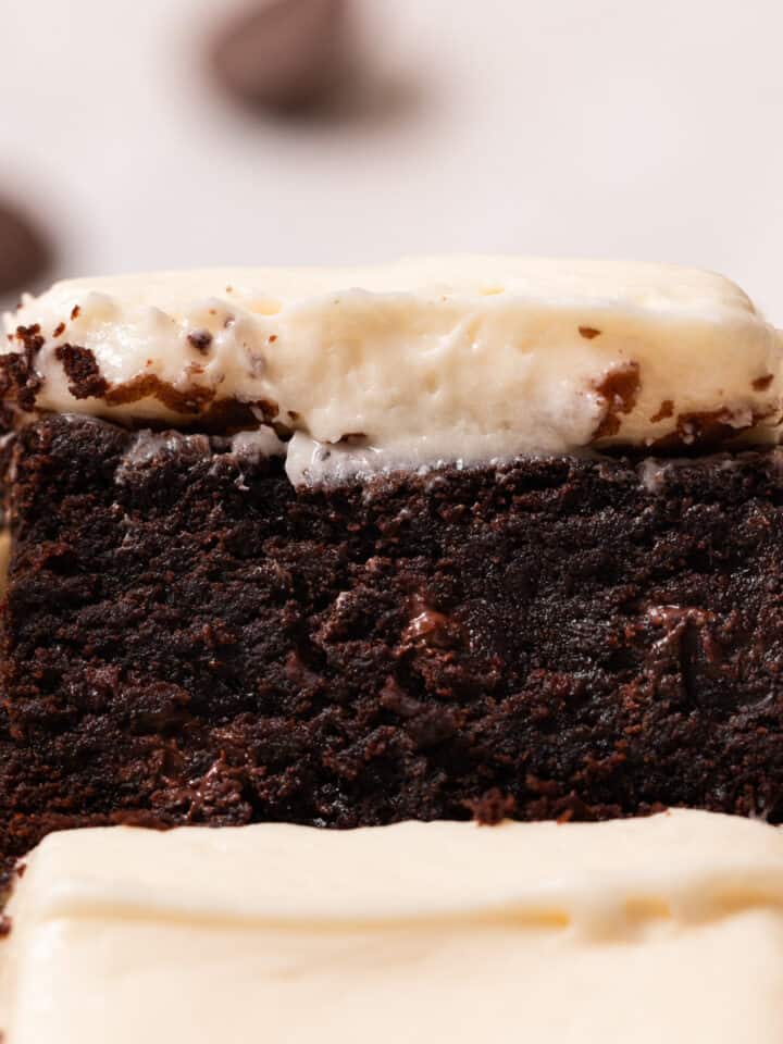 Close up of brownies with cream cheese frosting to show texture.