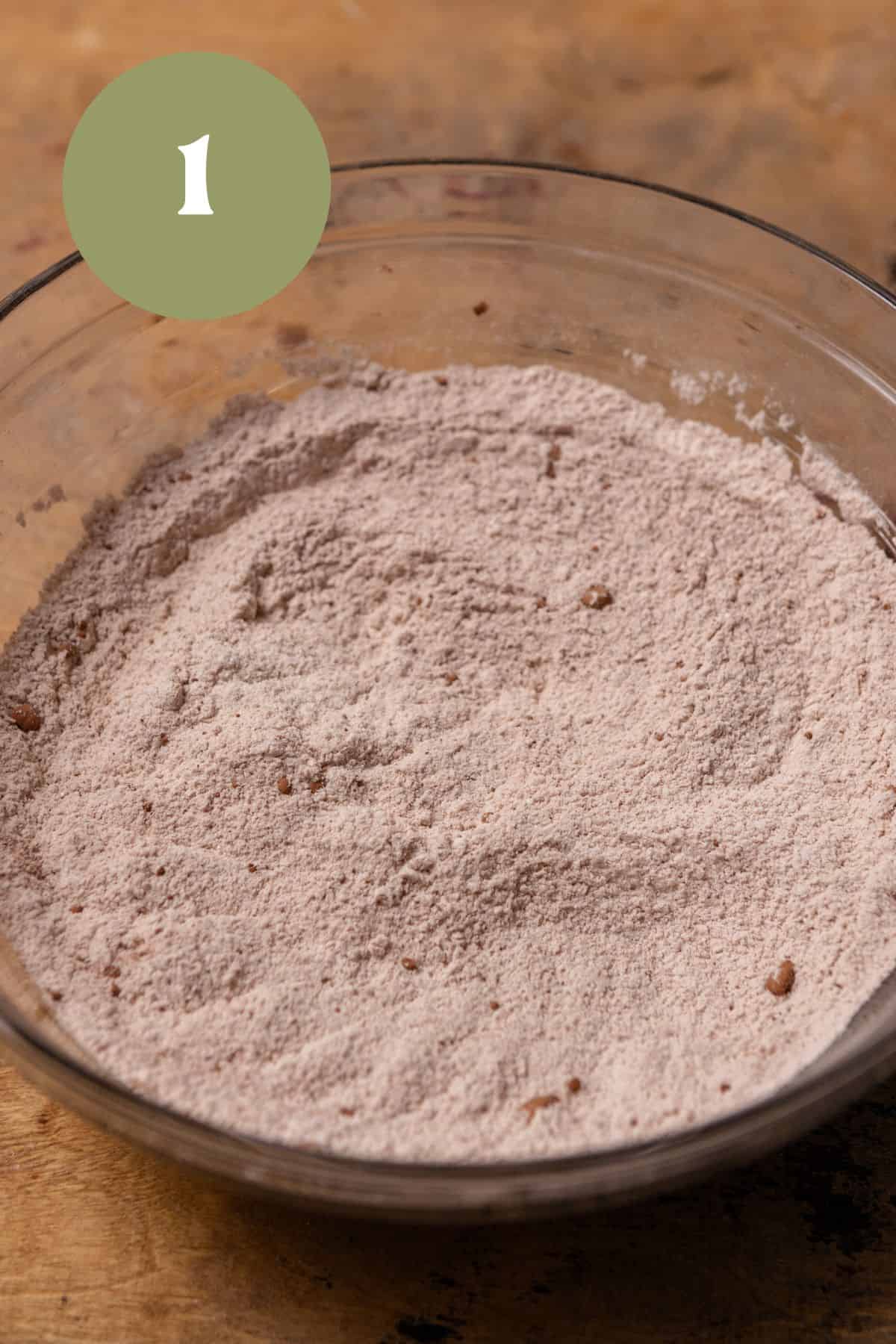Dry cake ingredients in a glass bowl.