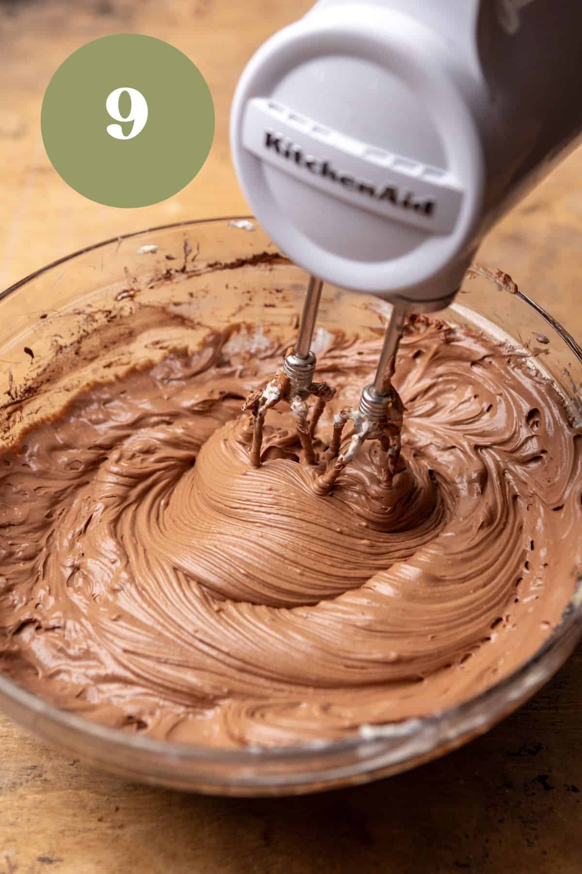 Mixing chocolate cheesecake batter in a bowl.
