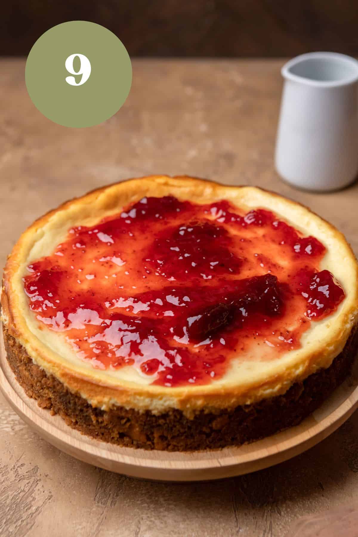 A cheesecake topped with strawberry jam.