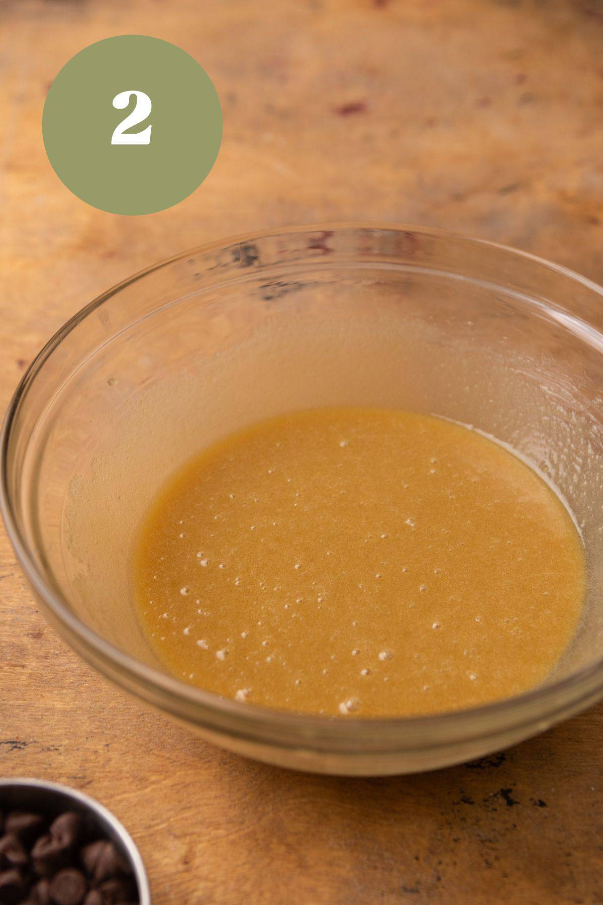 Wet ingredients for cookies in a glass bowl.