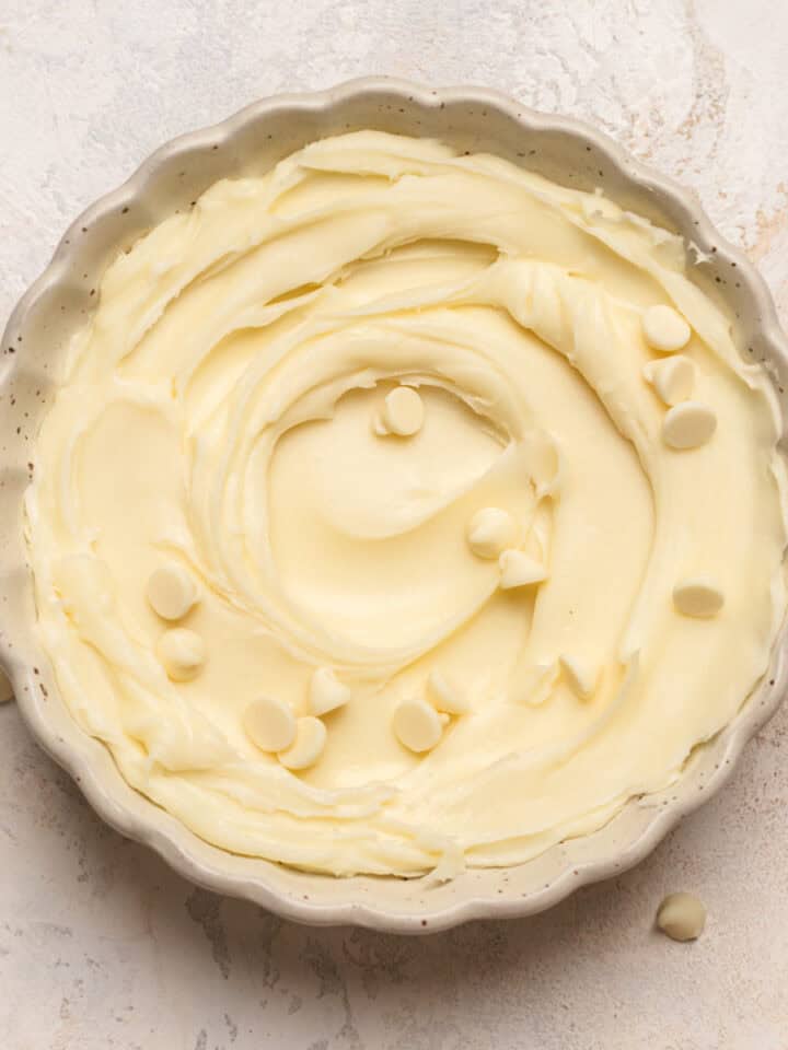 White chocolate ganache in a white scalloped bowl.