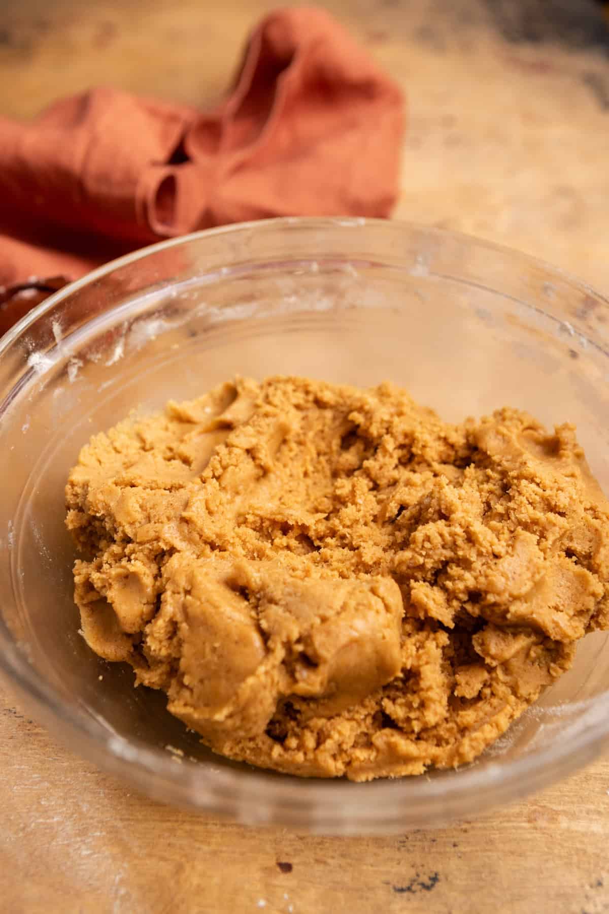 Cookie dough in a glass mixing bowl.