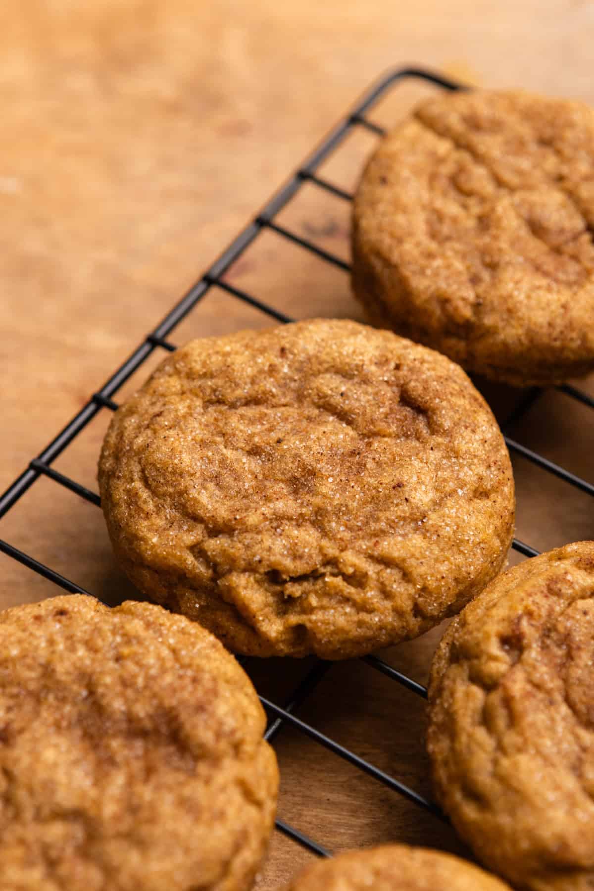 Baked pumpkin spice cookies on a wire cooling rack.