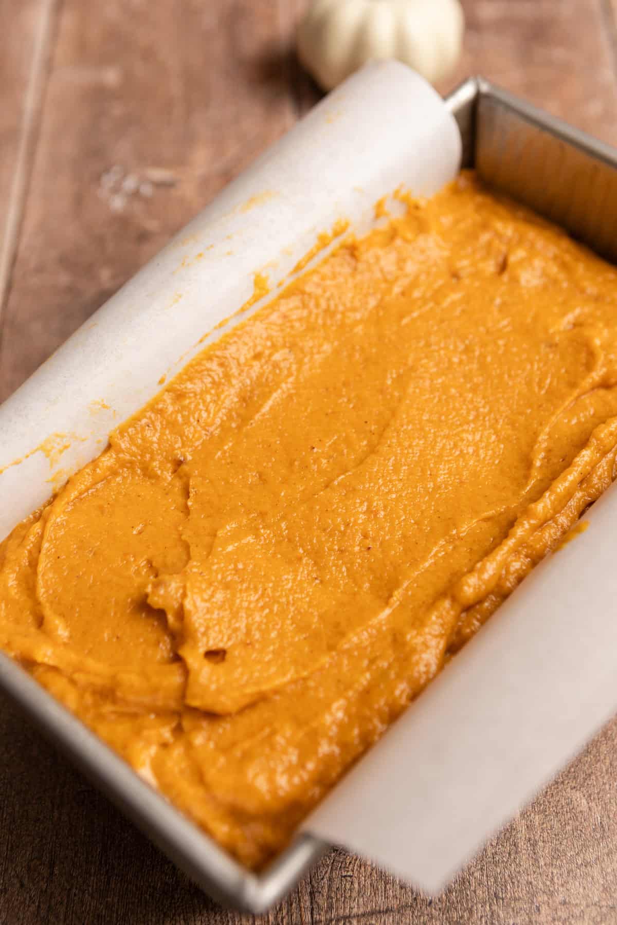 An unbaked loaf of pumpkin bread.
