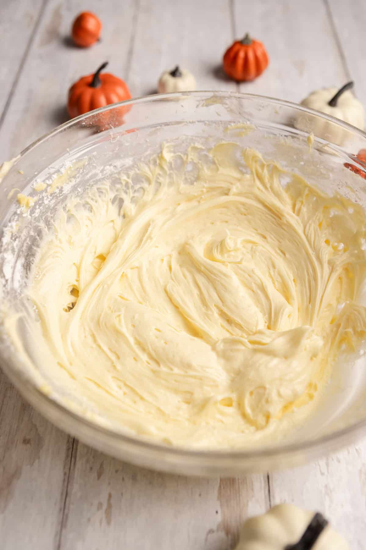 Butter combined with powdered sugar in a bowl.