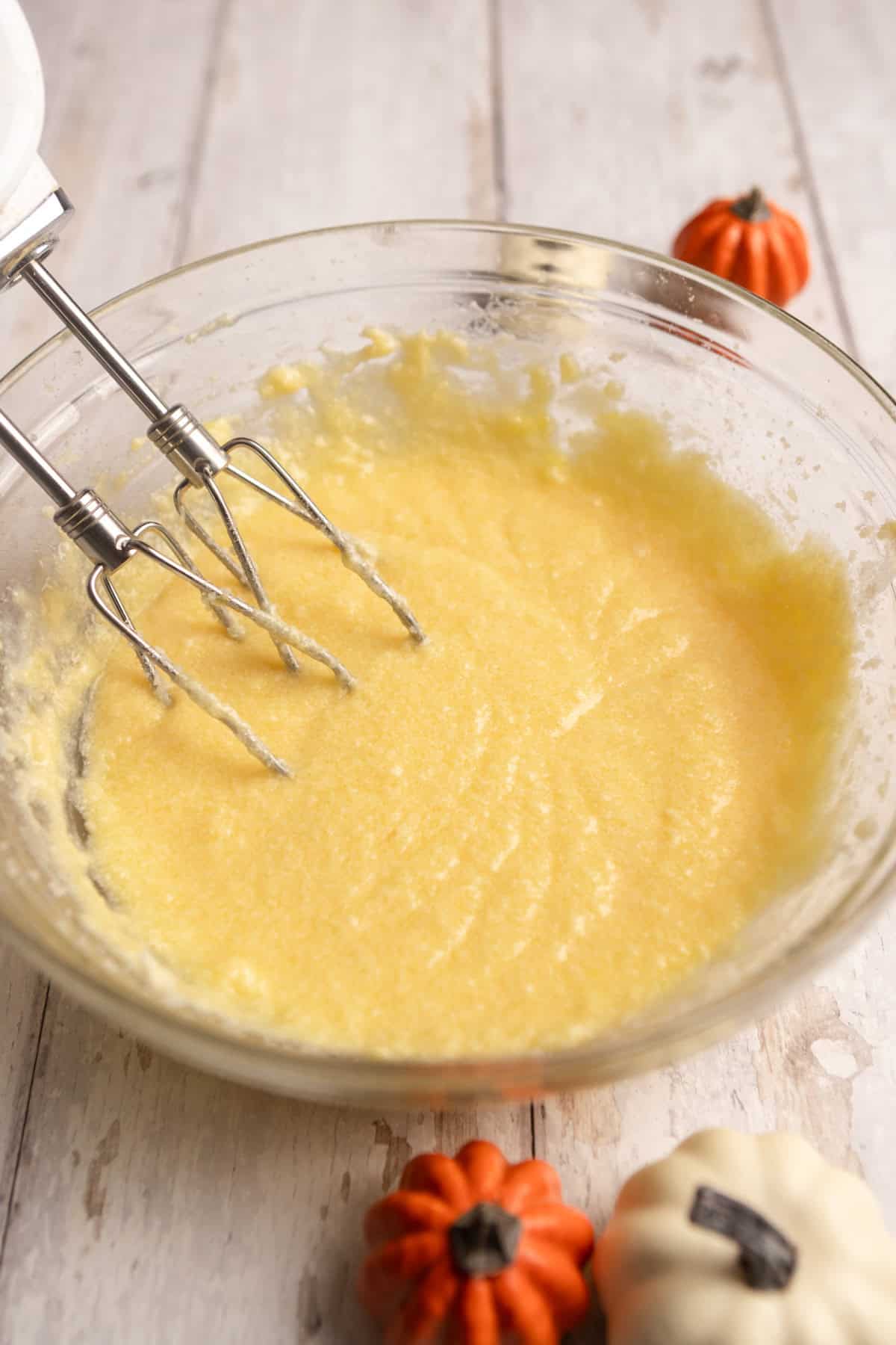 Wet ingredients in a bowl with a mixer.