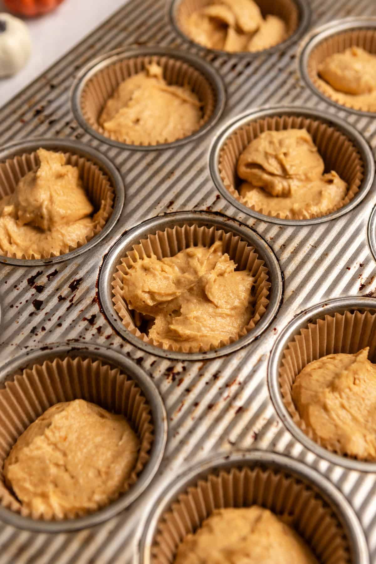 Unbaked cupcakes in a cupcake pan.