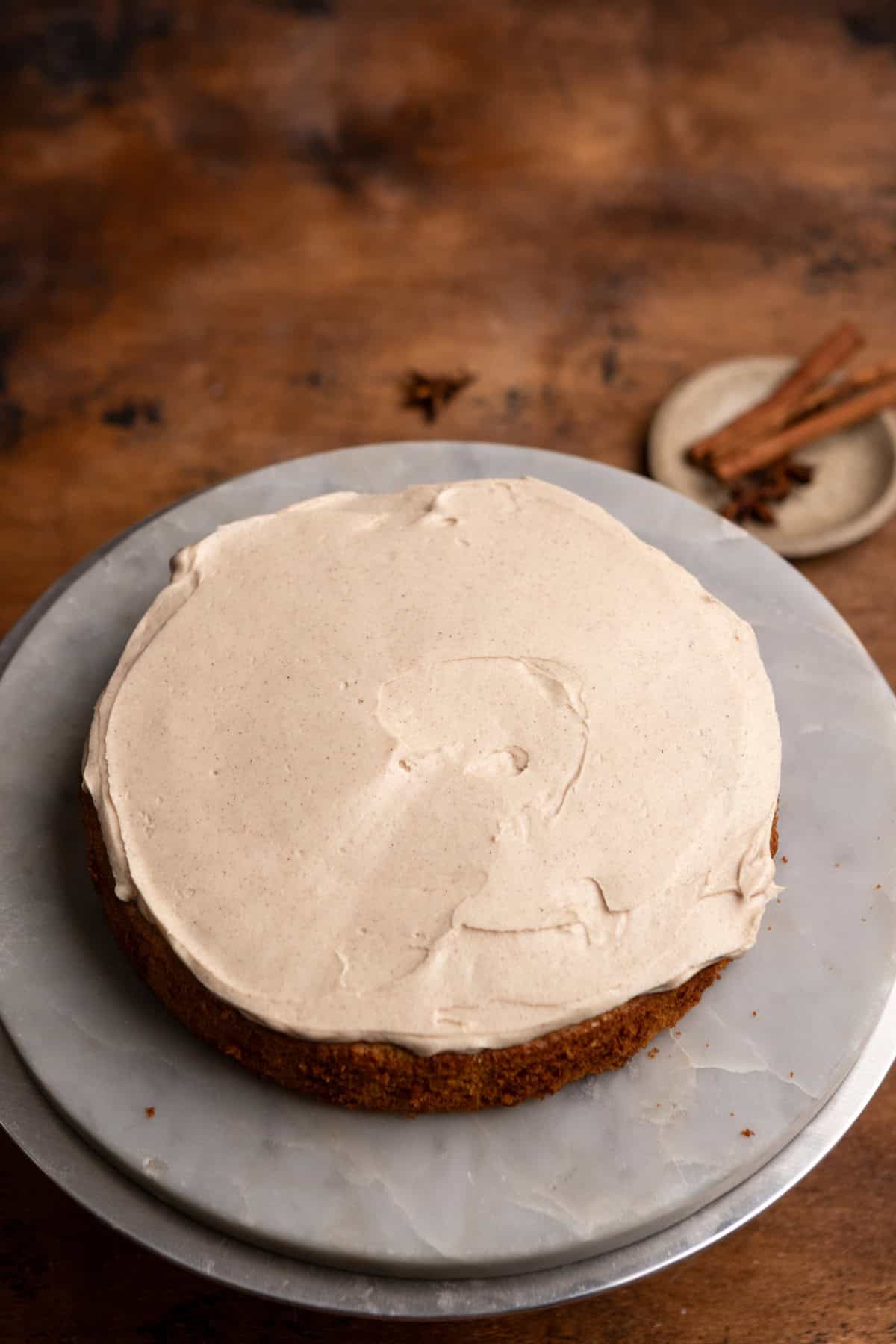 A layer of cake with frosting on it.