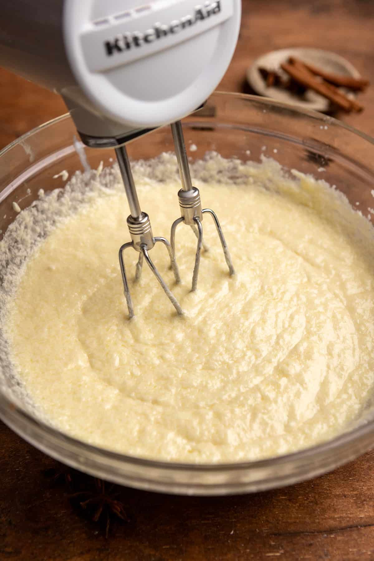 Wet ingredients in a bowl with a mixer.