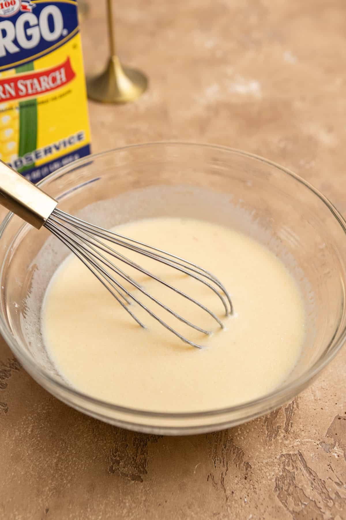 Wet ingredients mixed in a bowl with a whisk.