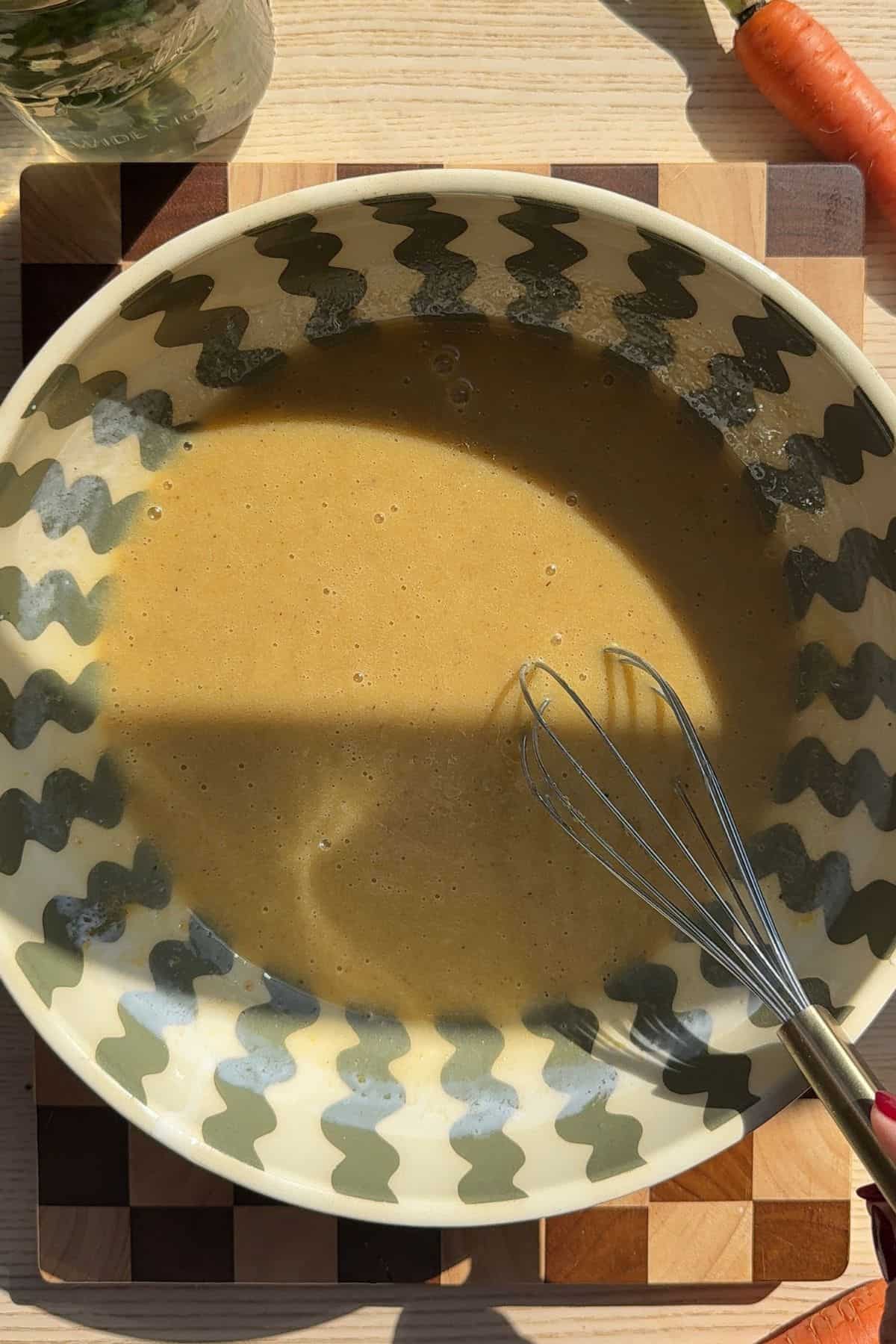 Wet ingredients for muffins mixed together in a large mixing bowl.