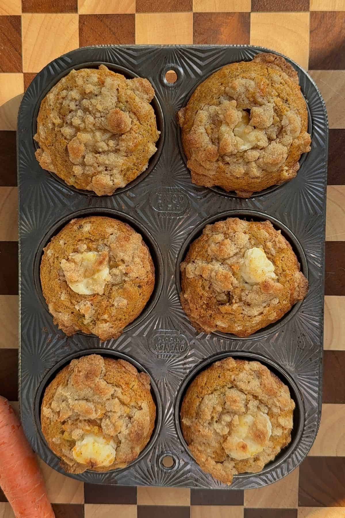 Baked muffin in an aluminum muffin tin.