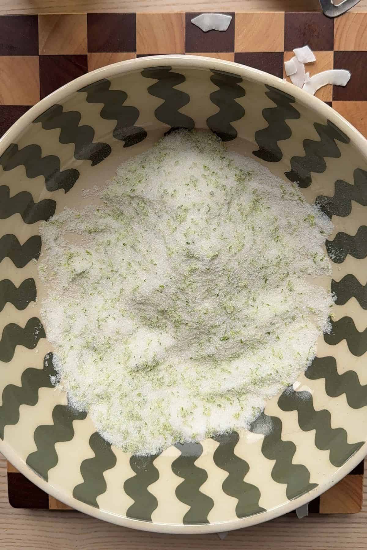 Sugar and lime zest in a bowl.
