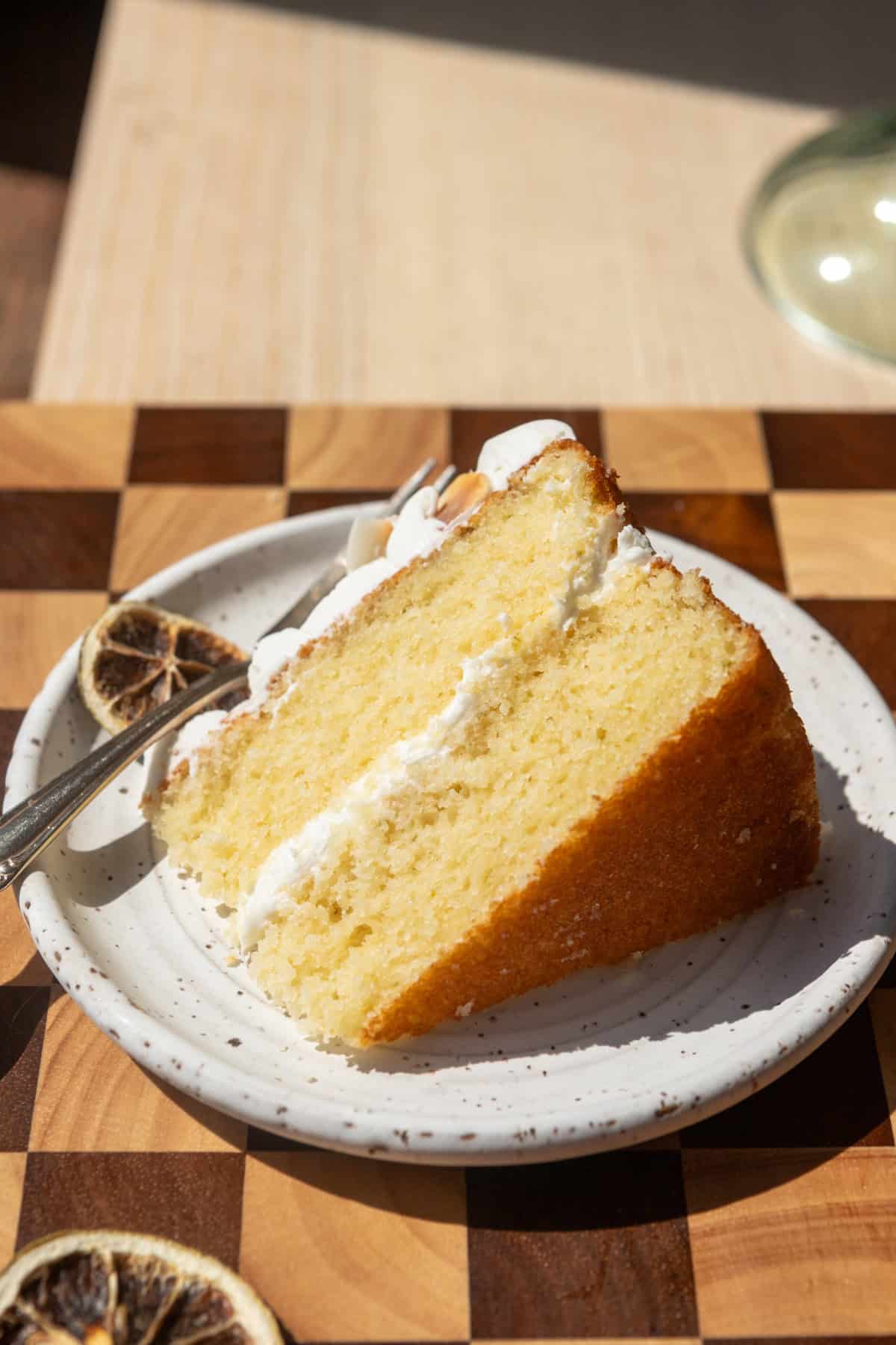 A slice of lime coconut cake on a white plate.