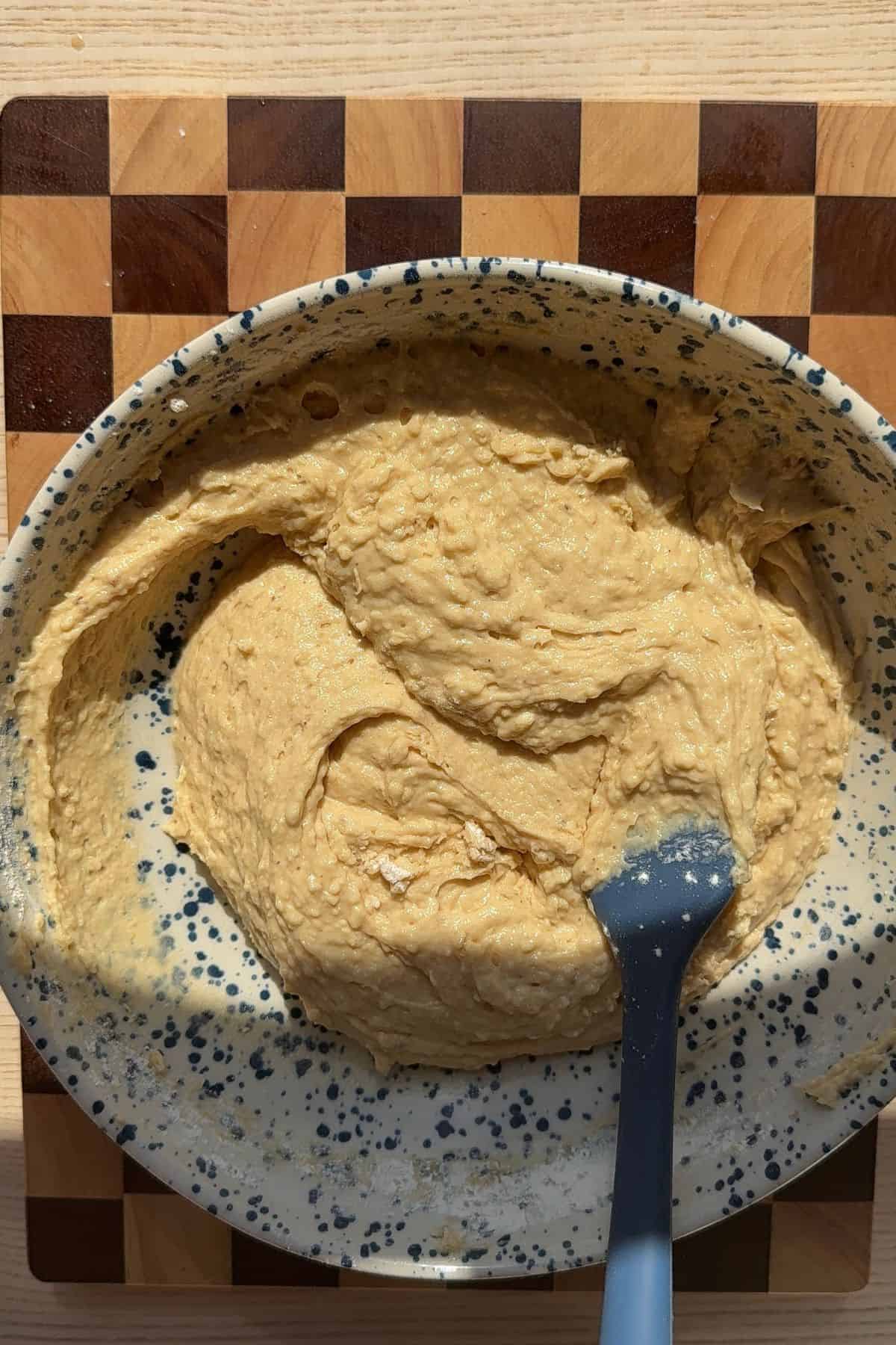Irish cream coffee cake batter in a bowl with a whisk.