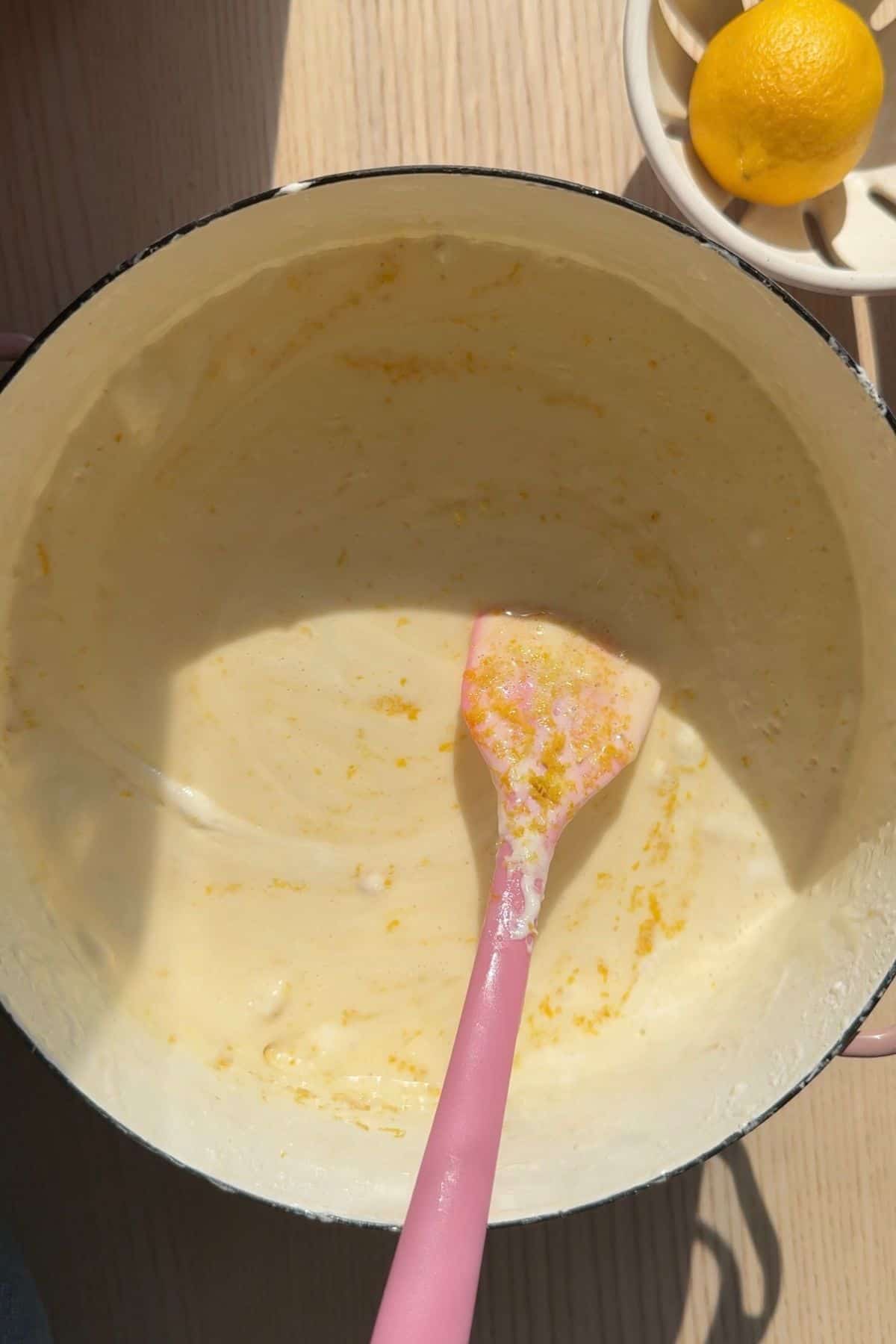 Melted butter, marshmallows, and lemon juice in a pot with a rubber spatula.