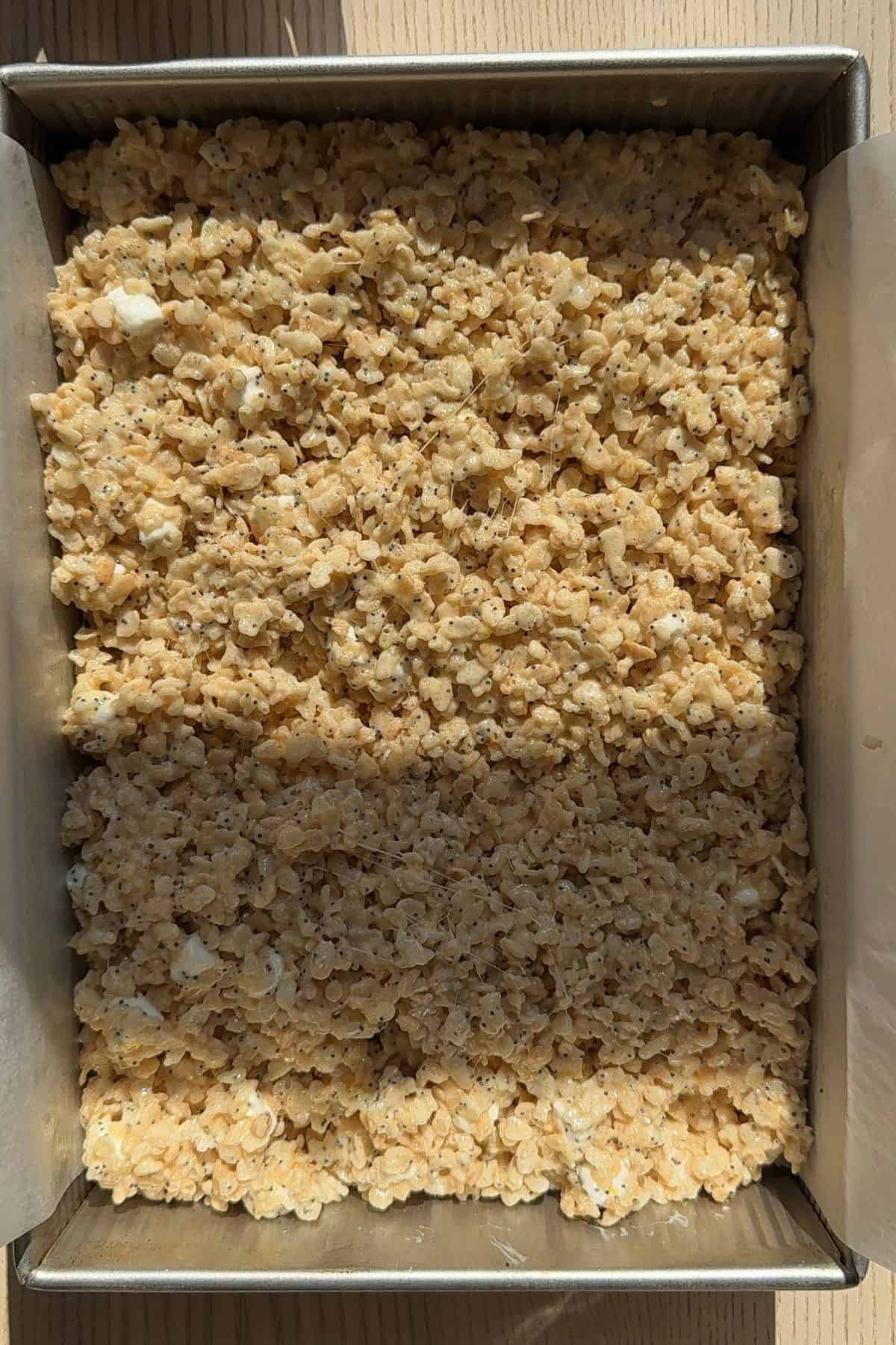 Uncut lemon poppyseed Rice Krispie treats in a pan.