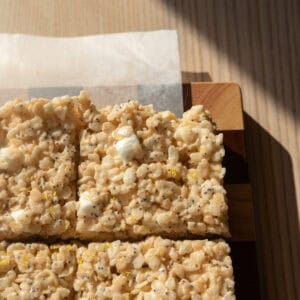 Lemon poppy seed Rice Krispie treats on a checkered board.