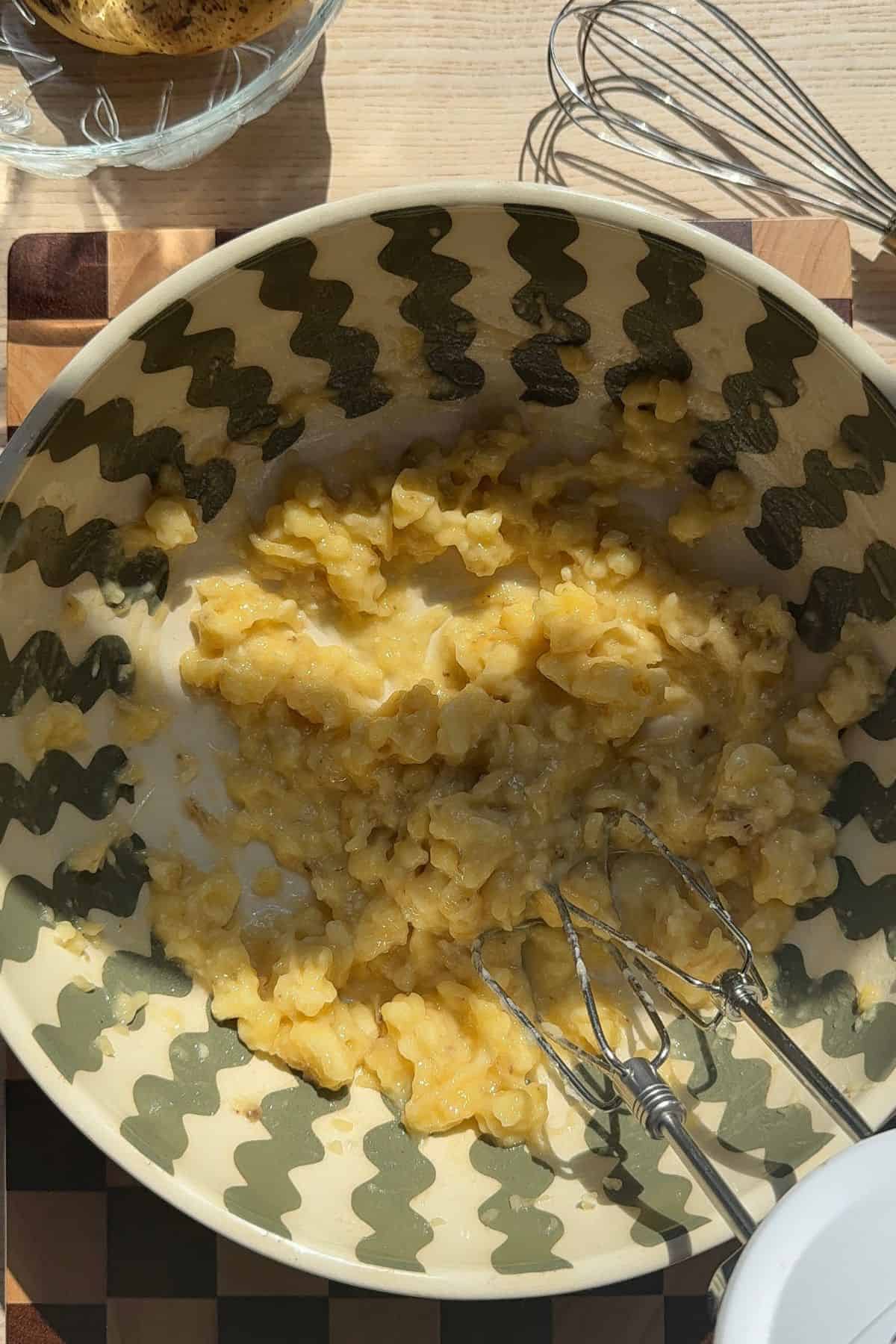Mashed bananas in a large bowl.